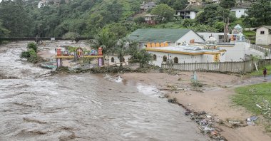 Floodwaters wash through a property near Durban, South Africa, April 23, 2019. (AP Photo)