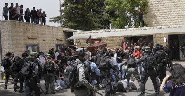 Israeli police attack mourners as they carry the coffin of slain Al Jazeera veteran journalist Shireen Abu Akleh during her funeral in East Jerusalem, Palestine, May 13, 2022. (AP Photo)