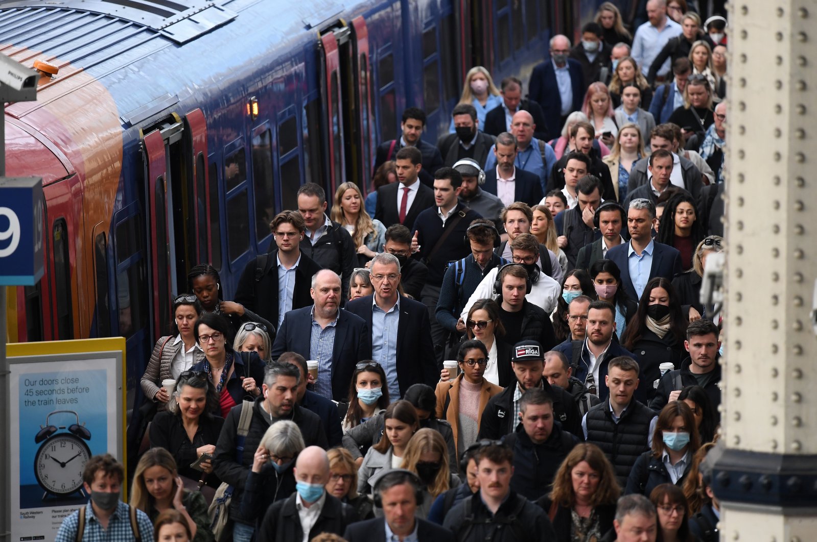 Commuters walk on the platform at Waterloo Station in London, Britain, April 19, 2022. (EPA Photo)