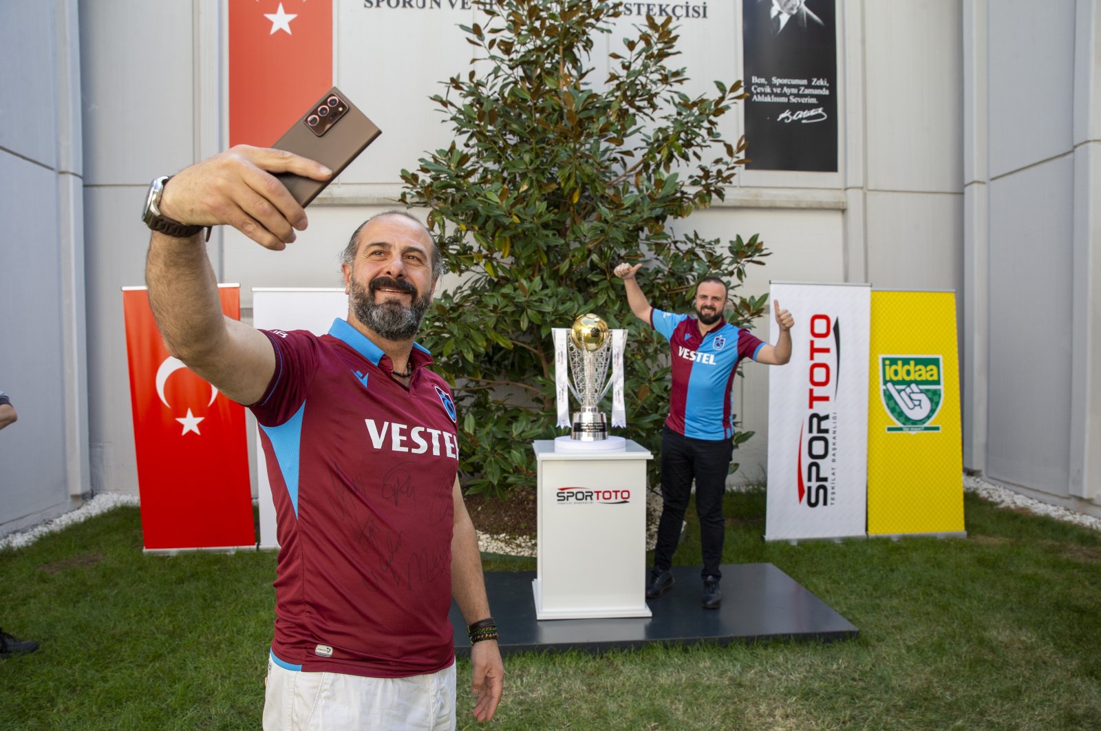 Two Trabzonspor fans pose with the Süper Lig trophy, Istanbul, Turkey, May 10, 2022. (AA Photo)