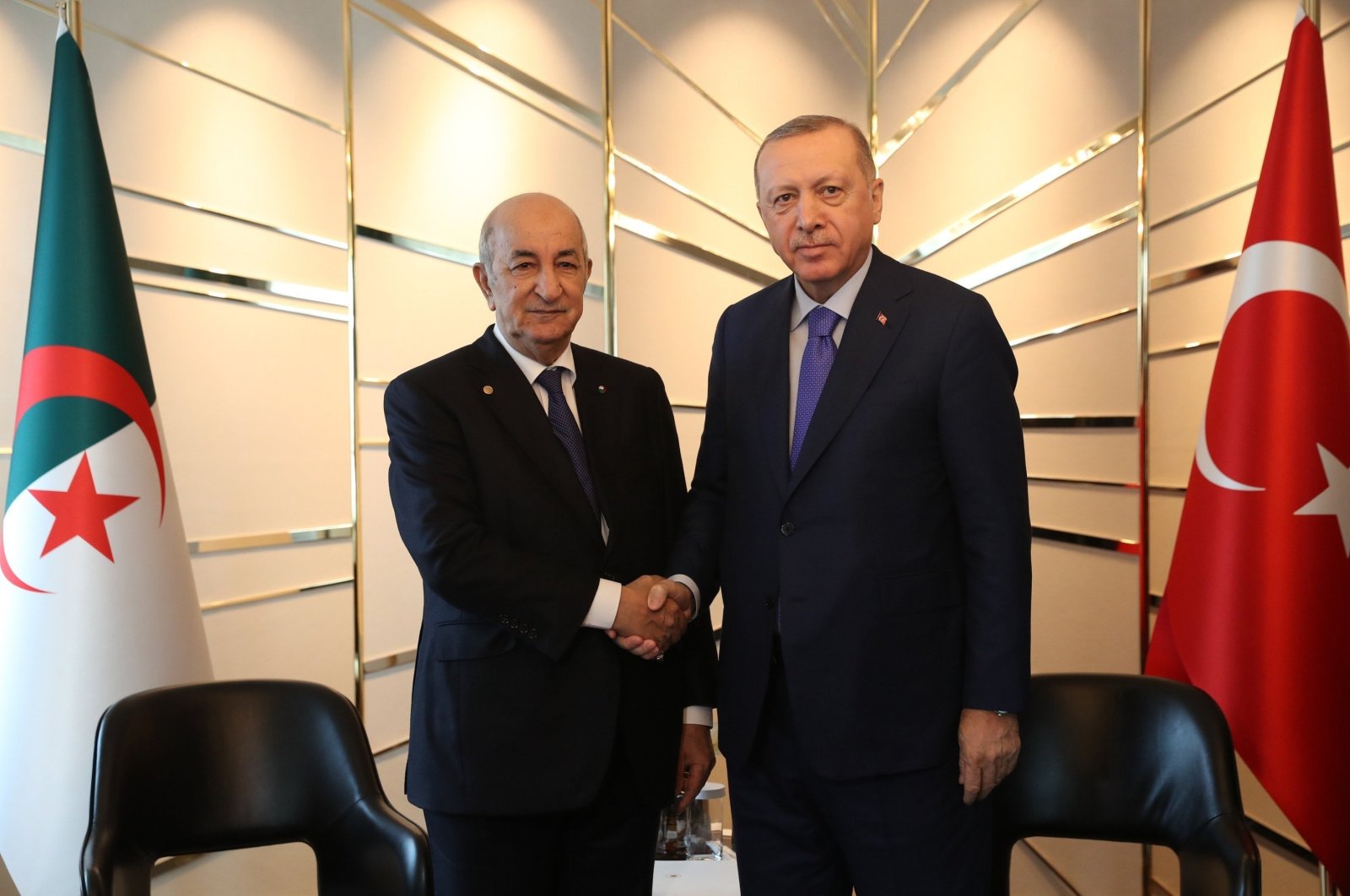 Turkish President Recep Tayyip Erdoğan (R) shakes hands with Algerian President Abdelmadjid Tebboune ahead of a conference on Libya in Berlin, Germany, Jan. 21, 2020. (IHA)