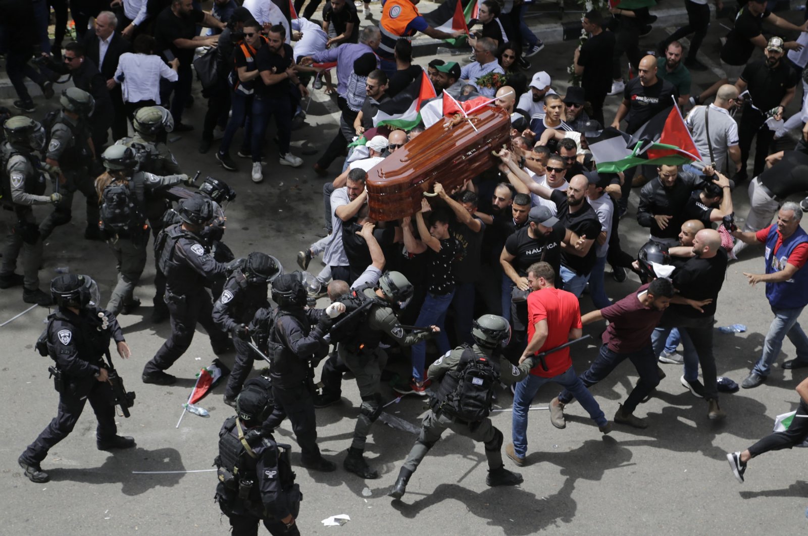 Israeli police attack mourners as they carry the casket of slain Al-Jazeera veteran journalist Shireen Abu Akleh during her funeral, East Jerusalem, occupied Palestine, May 13, 2022. (AP Photo)