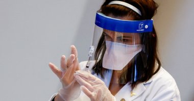 A medical worker prepares a syringe with a dose of the Johnson &amp; Johnson COVID-19 vaccine during a visit of U.S. Vice President Kamala Harris to a vaccination center in Chinatown, Chicago, Illinois, U.S., April 6, 2021. (Reuters Photo)