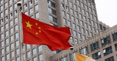 Flags of China and China Resources (Holdings) Co. Ltd. logo flutter outside a China Resources building in Beijing, China, May 12, 2022. (Reuters Photo)