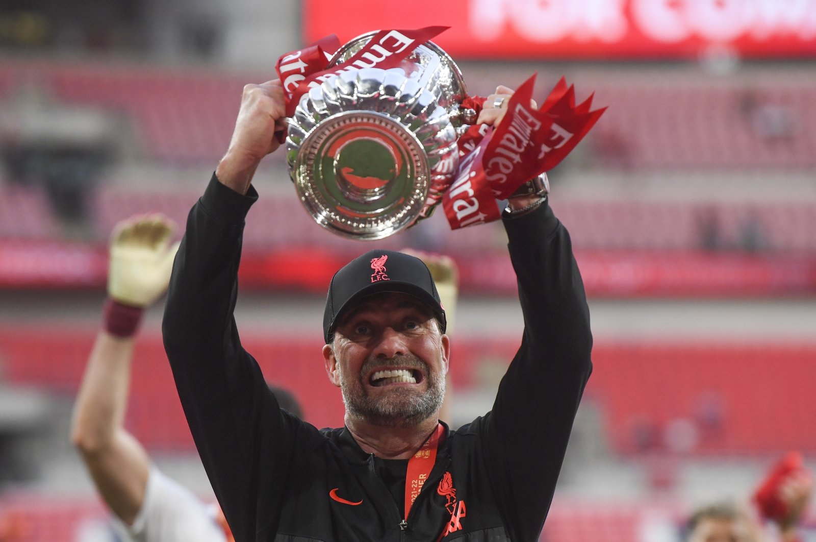 Liverpool manager Juergen Klopp celebrates with the FA Cup trophy, London, England, May 14, 2022. (EPA Photo)