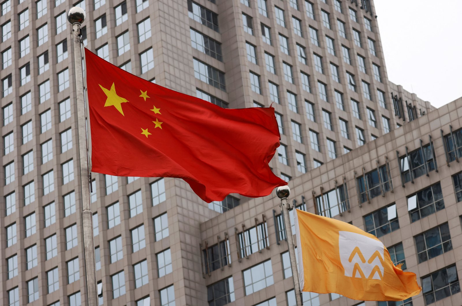 Flags of China and China Resources (Holdings) Co. Ltd. logo flutter outside a China Resources building in Beijing, China, May 12, 2022. (Reuters Photo)