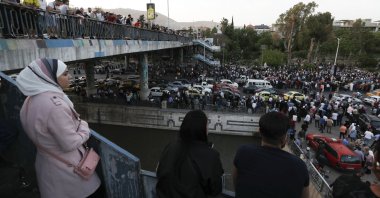 Dozens of Syrians wait at the President's Bridge in Damascus for relatives they hope would be among those released from prison, Syria, May 3, 2022. (AP Photo)