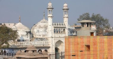 A worker stands on a temple rooftop adjacent to the Gyanvapi Mosque in the northern city of Varanasi, India, Dec. 12, 2021. (Reuters Photo)