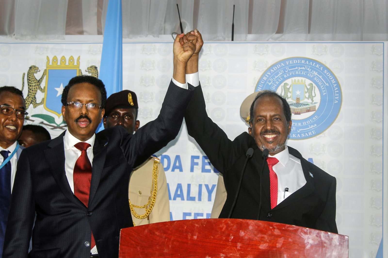 Hassan Sheikh Mohamud (R) marks his election win with incumbent leader Mohamed Abdullahi Mohamed (L) at the Halane military camp in Mogadishu, Somalia, Sunday, May 15, 2022. (AP Photo)