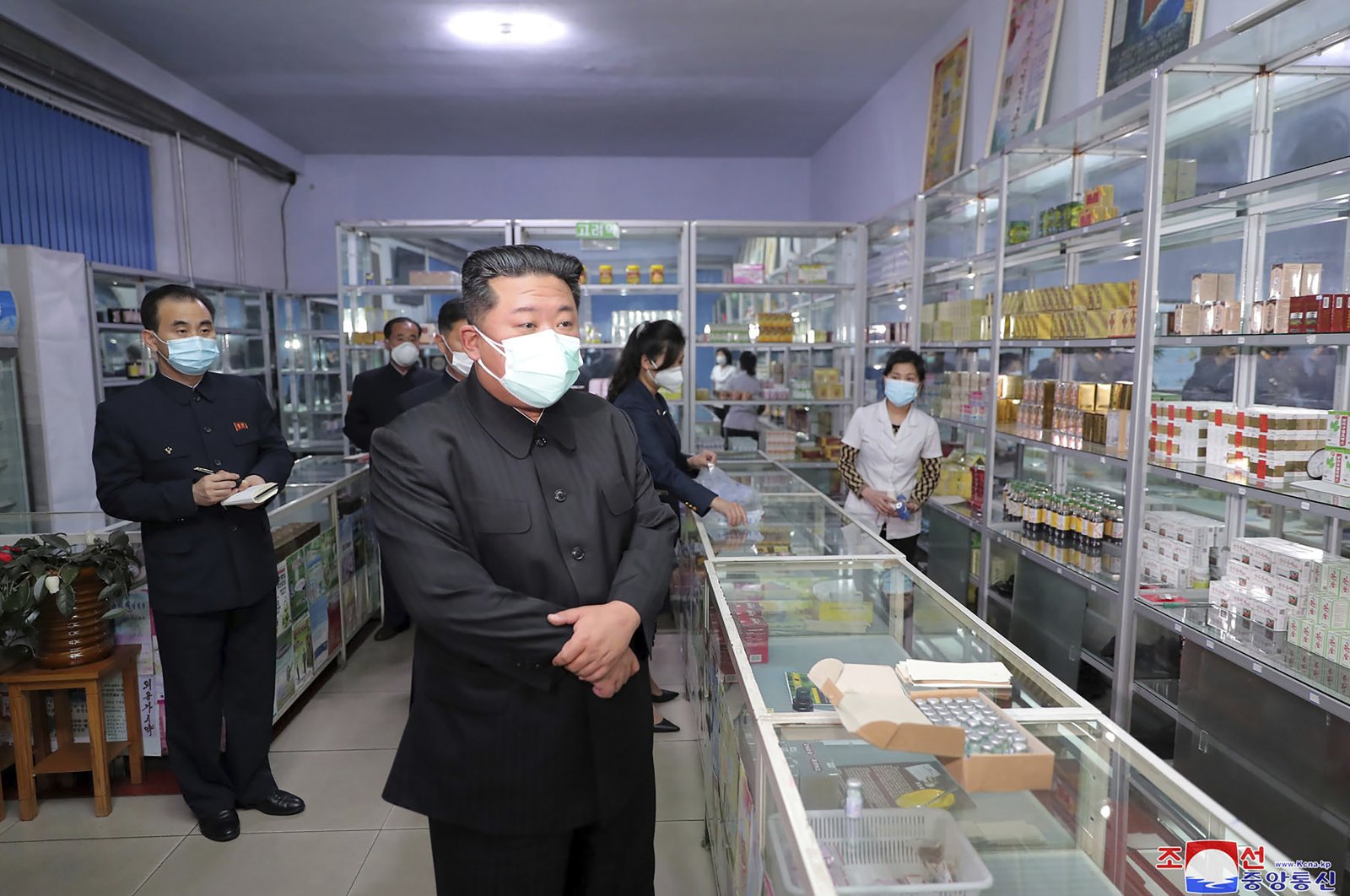 North Korean leader Kim Jong Un (C) visits a pharmacy in Pyongyang, North Korea, Sunday, May 15, 2022. (AP Photo)