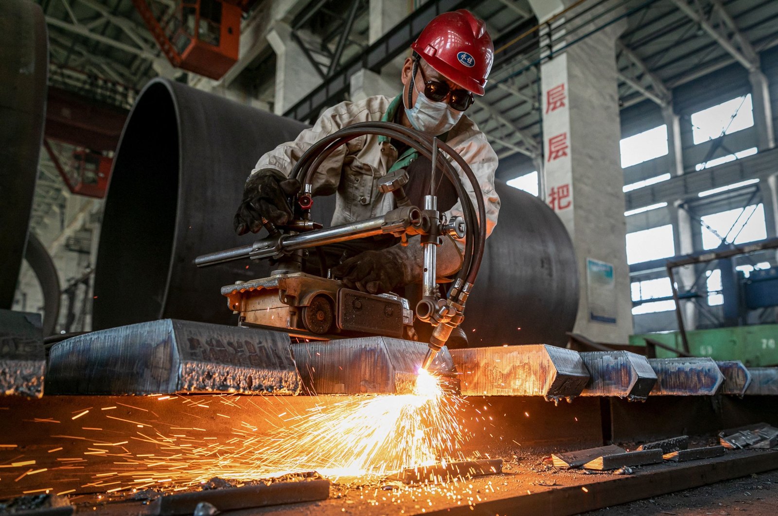 A worker produces manufacturing machinery at a factory in Nantong, in eastern Jiangsu province, China, May 26, 2021. (AFP Photo)