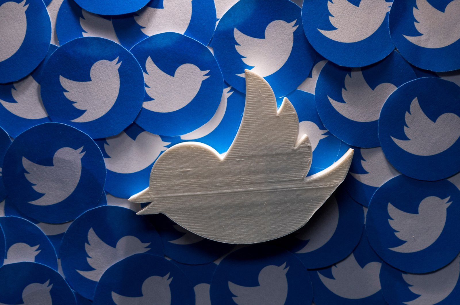 A 3D-printed Twitter logo on non-3D printed Twitter logos is seen in this picture illustration, April 28, 2022. (Reuters Photo)