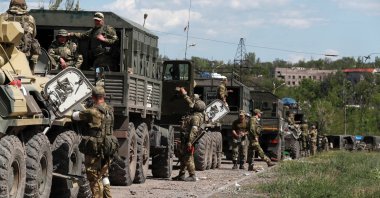 A convoy of pro-Russian troops is seen before the expected evacuation of wounded Ukrainian soldiers from the besieged Azovstal steel mill in the course of Ukraine-Russia conflict in Mariupol, Ukraine, May 16, 2022. (Reuters Photo)