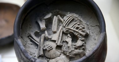 A 5,000-year-old cube tomb containing a baby&#039;s skeleton, which was unearthed during the excavations at the Arslantepe Mound, has been unveiled. (AA Photo)