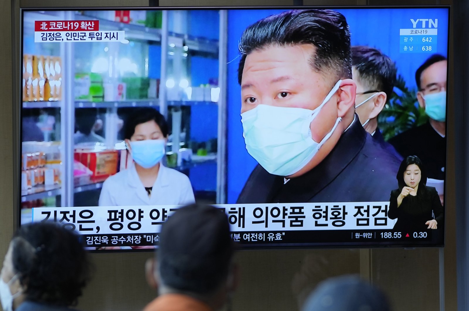 People watch a TV screen showing a news program reporting with an image of North Korean leader Kim Jong Un, at a train station in Seoul, South Korea, May 16, 2022. (AP Photo)