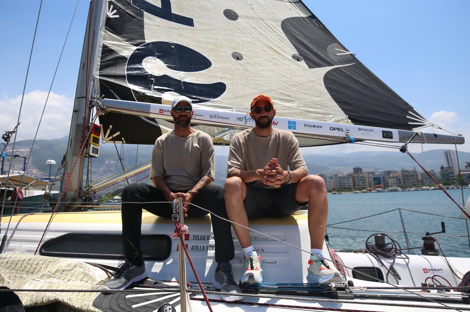Tolga and Atilla Gökova pose on their sailboat, Iskenderun, Turkey, May 17, 2022. (AA Photo)