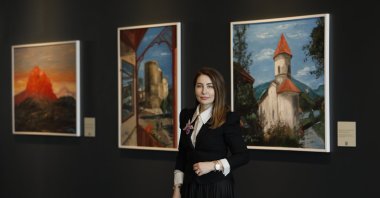 Nigar Helmi Abbasbayli poses with her works at the Atatürk Cultural Center, Istanbul. 