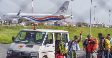 Ukrainian mountaineer Antonina Samoilova waves as she arrives at the airport after climbing Mount Everest, in Kathmandu, Nepal, May 17, 2022. (AP Photo)