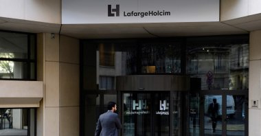 A pedestrian walks in front of the entrance to the headquarters of French cement producer Lafarge in Paris, France, Nov. 14, 2017. (AFP Photo)