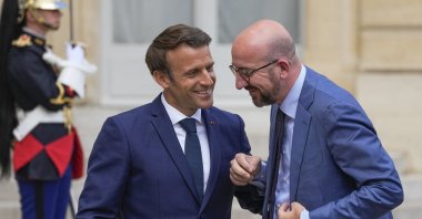French President Emmanuel Macron (L) greets European Council President Charles Michel for lunch at the Elysee Palace, Paris, France, May 16, 2022. (AP Photo)