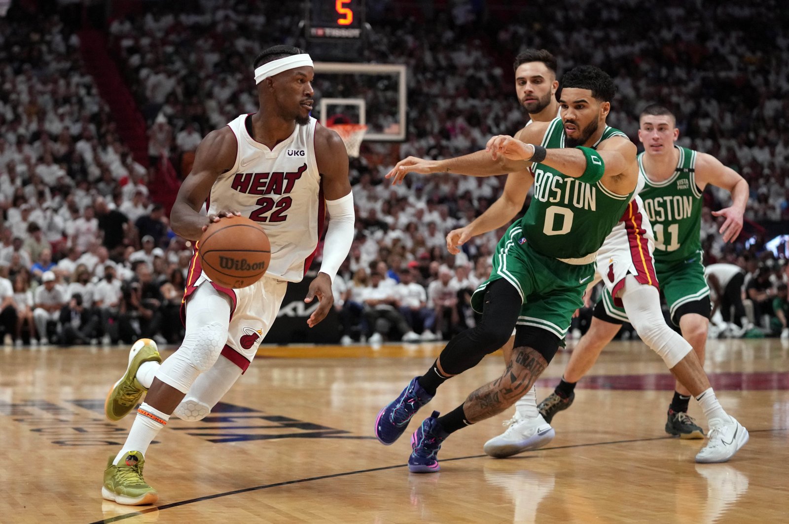 Heat forward Jimmy Butler (L) moves against Celtics forward Jayson Tatum (R) during an NBA Eastern Conference finals game, Miami, U.S., May 17, 2022. (Reuters Photo)