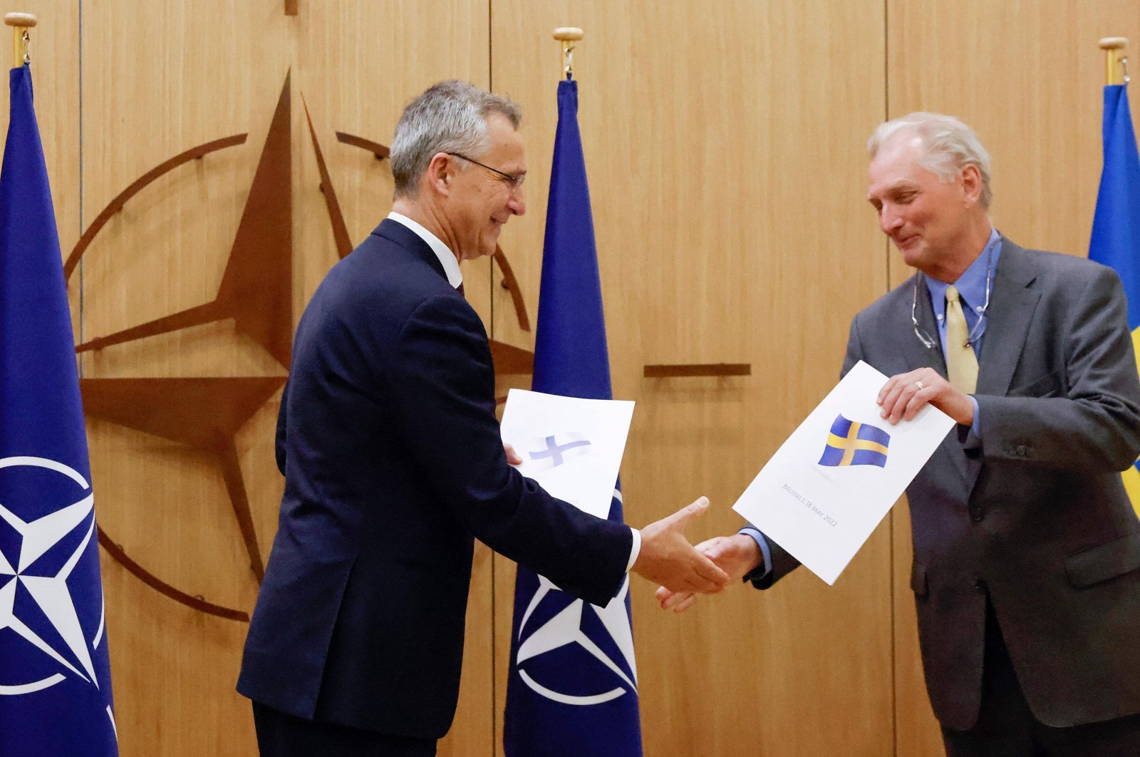 NATO Secretary-General Jens Stoltenberg (L) shakes hands with Sweden&#039;s Ambassador to NATO Axel Wernhoff (R) during a ceremony to mark Sweden&#039;s and Finland&#039;s application for membership in Brussels, Belgium, May 18, 2022. (AFP Photo)