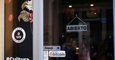 A sign reads &quot;Bitcoin accepted here&quot; outside a coffee shop where the cryptocurrency is accepted as a payment method in San Salvador, El Salvador, May 15, 2022. (Reuters Photo)