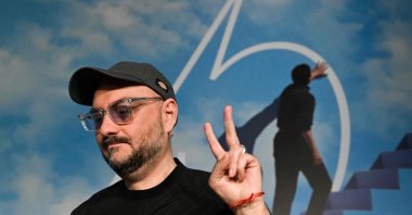 Russian director Kirill Serebrennikov flashes the victory sign as he arrives to attend a press conference for the film "Tchaikovsky's Wife" ("Zhena Chaikovskogo") at the 75th edition of the Cannes Film Festival in Cannes, southern France, on May 19, 2022. (AFP)