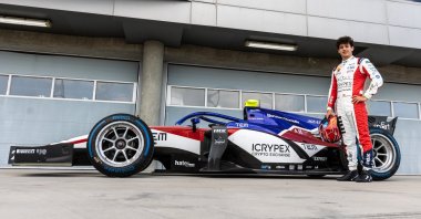 In this undated photo, Turkish driver Cem Bölükbaşı is seen with his Formula 2 car. (AA Photo)