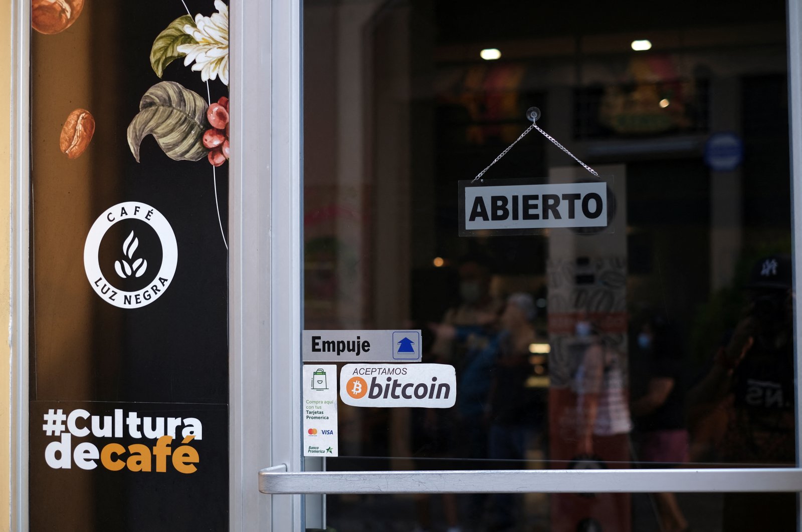 A sign reads &quot;Bitcoin accepted here&quot; outside a coffee shop where the cryptocurrency is accepted as a payment method in San Salvador, El Salvador, May 15, 2022. (Reuters Photo)