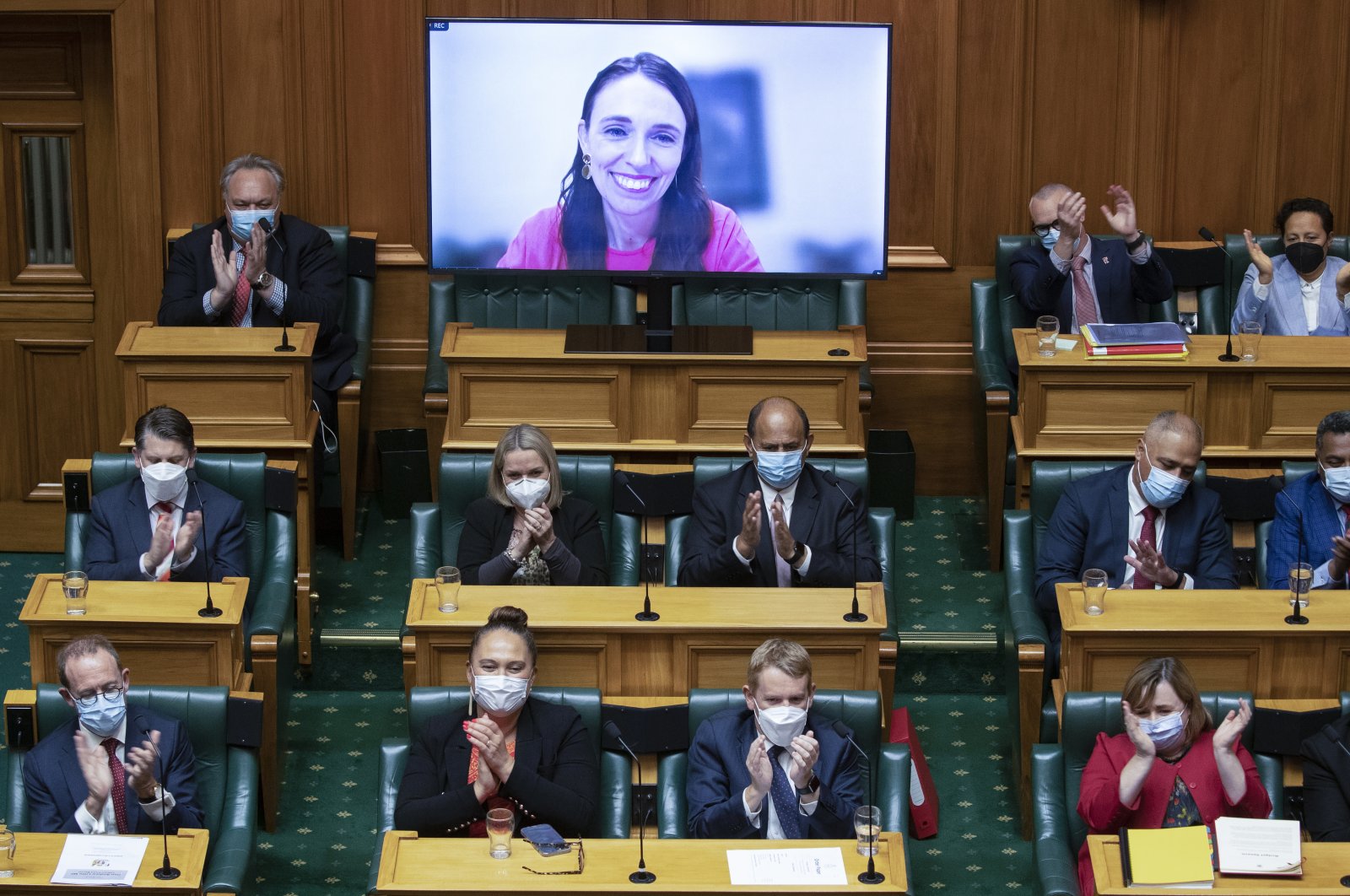 New Zealand Prime Minister Jacinda Ardern receives applause from colleagues after her address to parliament via a video link as she isolates herself at home after catching COVID-19 in Wellington, New Zealand, May 19, 2022. (AP Photo)