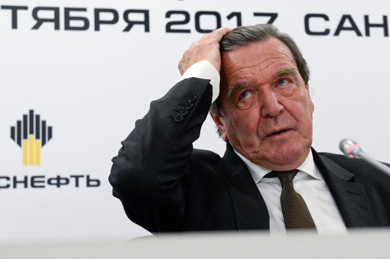 In this file photo taken on Sept. 29, 2017, former German Chancellor Gerhard Schroeder, then newly elected chairperson of the board of directors of Russia&#039;s oil giant Rosneft, reacts as he attends a briefing in Saint Petersburg, Russia. (AFP Photo)