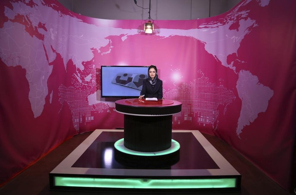 Basira Joya, presenter of the news program, sits during recording at the Zan TV station (women&#039;s TV) in Kabul, Afghanistan, May 30, 2017. (AP Photo)