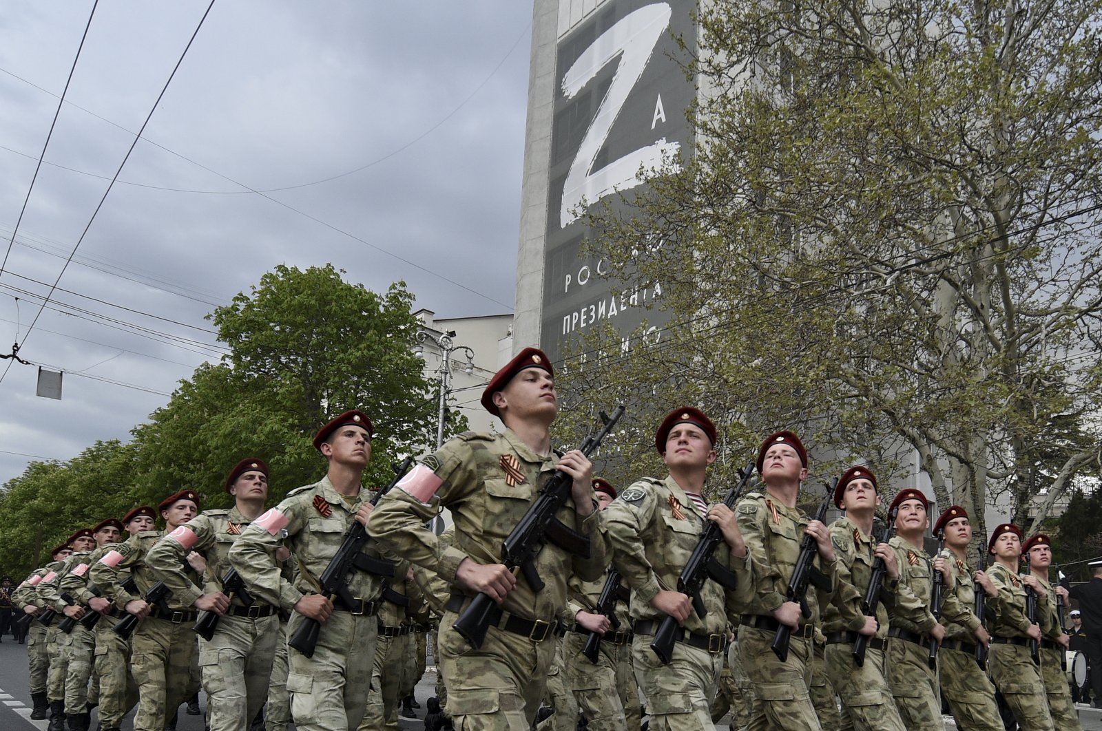 Russian National Guard (Rosguardia) forces march through a street with a letter Z, which has become a symbol of the Russian military on a building in Sevastopol, Crimea, Thursday, May 5, 2022.  (AP Photo)