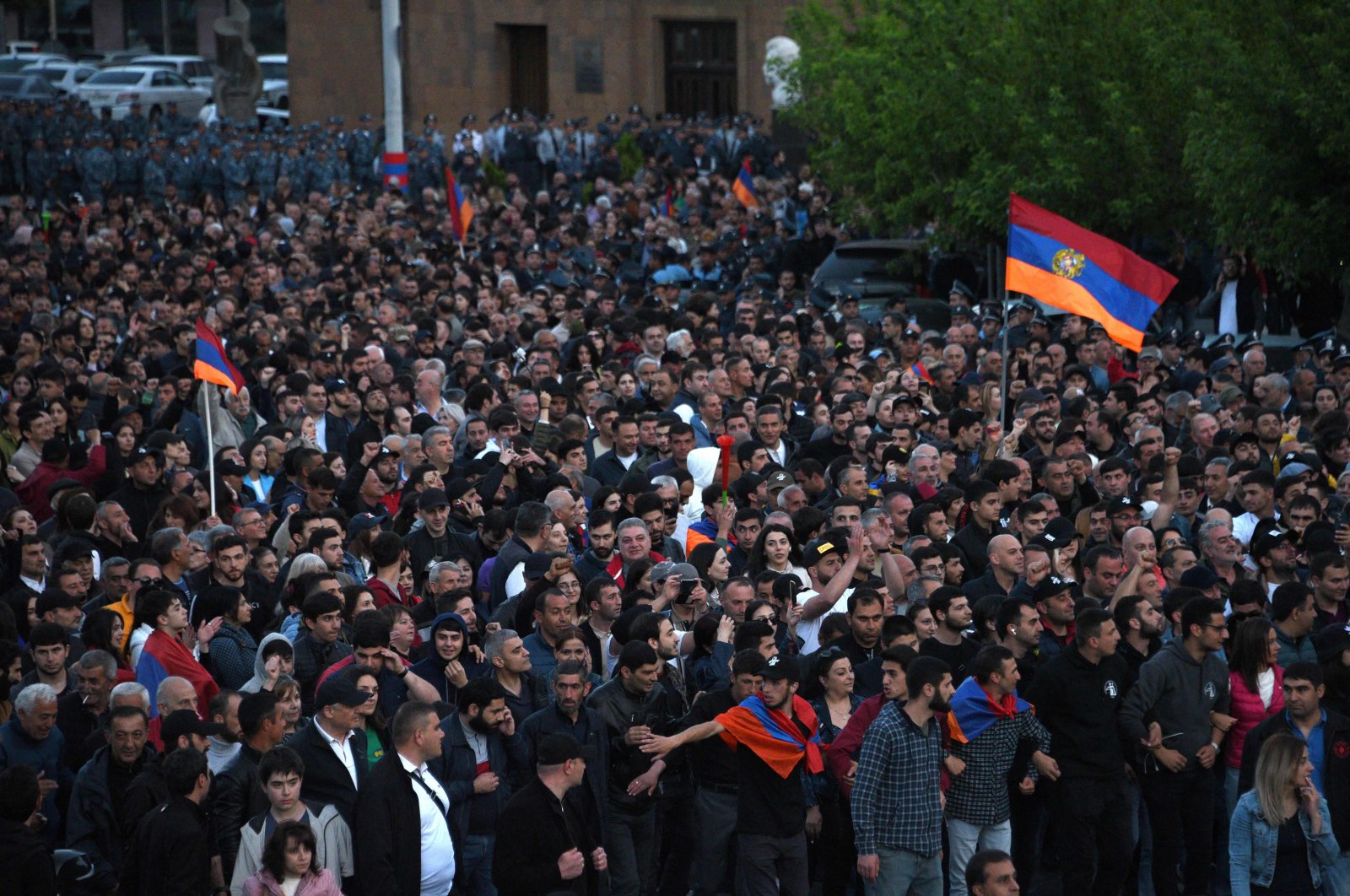 Protesters wave national flags during a rally called by opposition parties in a bid to oust the Prime Minister over his handling of a territorial dispute with arch-enemy Azerbaijan, in Yerevan, May 5, 2022. (AFP Photo)