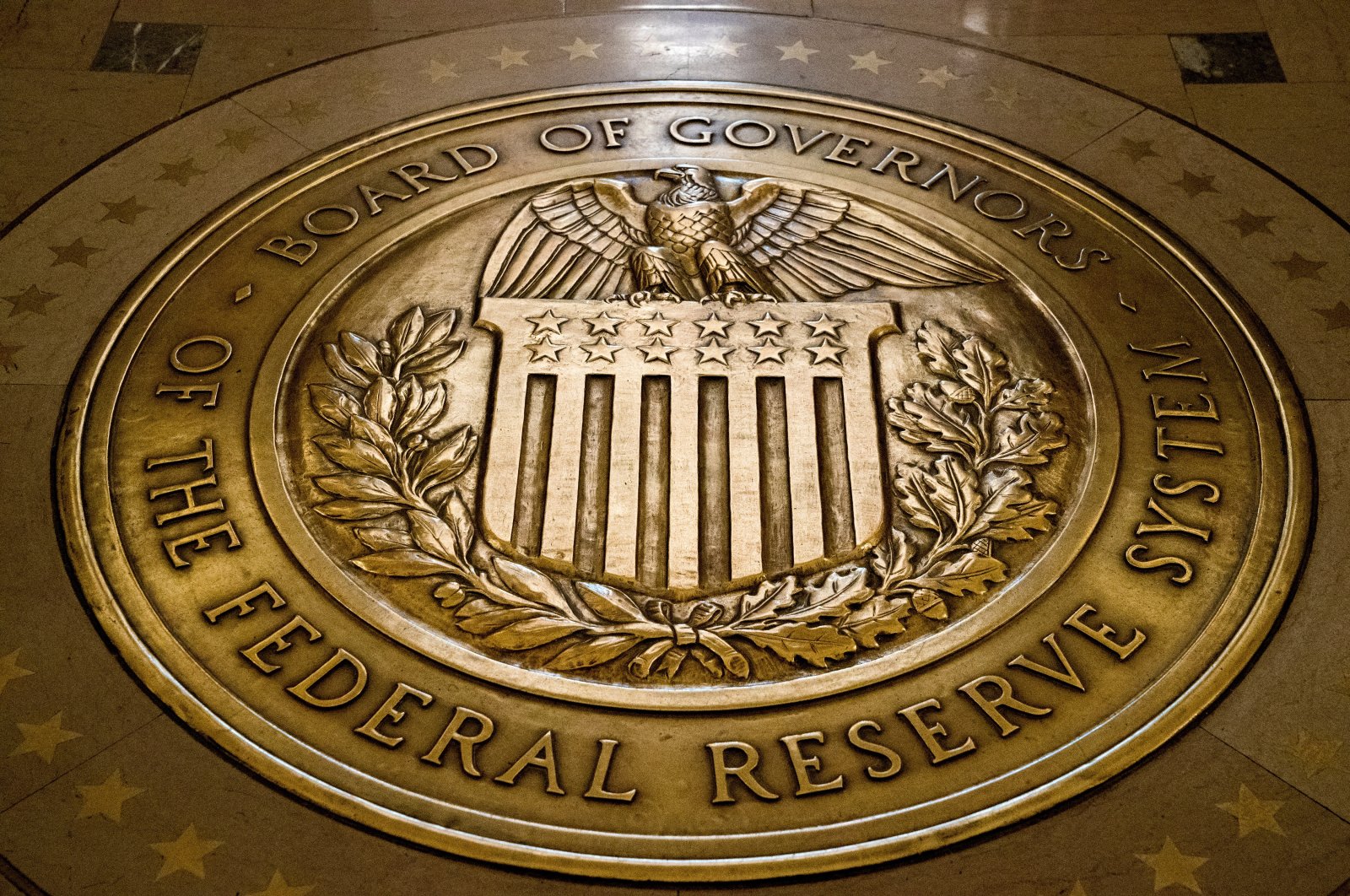 The seal of the Board of Governors of the U.S. Federal Reserve (Fed) is displayed in the ground at the Marriner S. Eccles Federal Reserve Board Building in Washington, U.S., Feb. 5, 2018. (AP Photo)