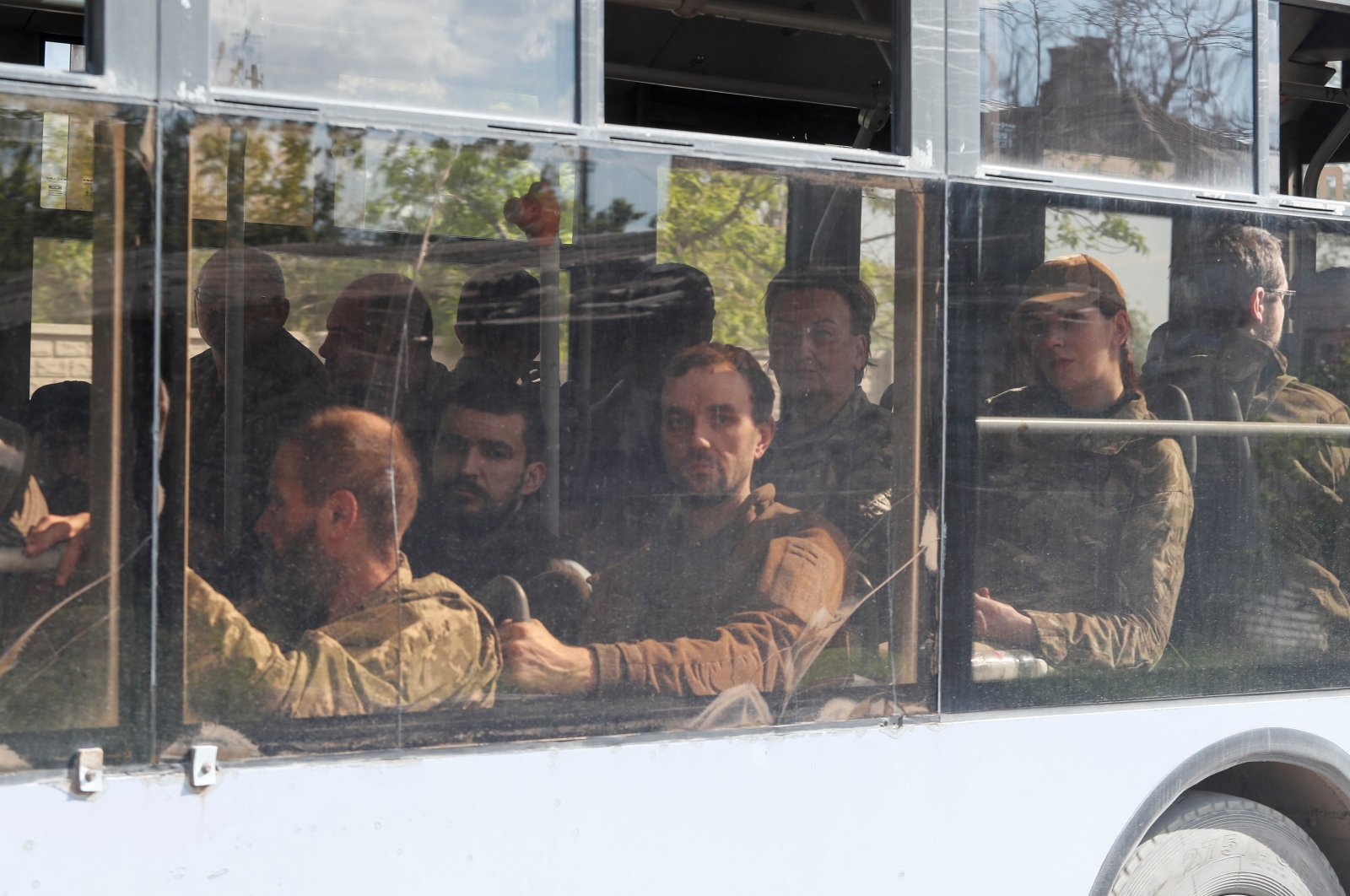 A bus carrying Ukrainian soldiers, who surrendered at the besieged Azovstal steel mill, drives away under the escort of the pro-Russian military, Mariupol, Ukraine, May 20, 2022. (Reuters Photo)