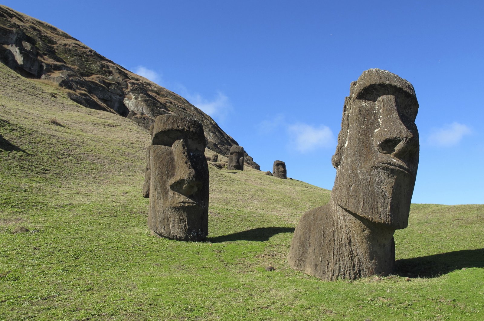 Statues of heads known as &quot;moais&quot; stand at Rano Raraku, the quarry on Easter Island or Rapa Nui, Chile, August 2012. Chile announced on May 20, 2022, the progressive reopening of Rapa Nui, the mysterious island of moai located in the middle of the Pacific Ocean, after almost two years of closure to protect it from the COVID-19 pandemic. (AP File Photo)