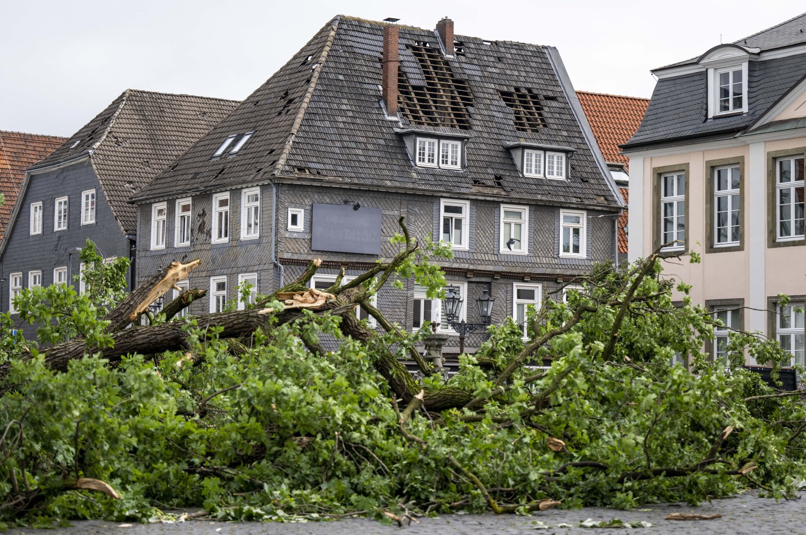 A view of the damaged roof of a residential building in Lippstadt, Germany, a day after heavy rains and storms hit the area, Germany, May 21, 2022. (dpa via AP)
