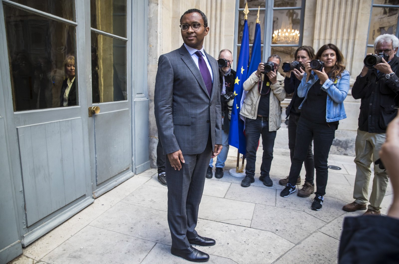 Newly-appointed French Education Minister Pap Ndiaye poses for photographs after the handover ceremony, amid attacks by far-right former presidential hopefuls, Paris, France, May 21, 2022. (EPA Photo)