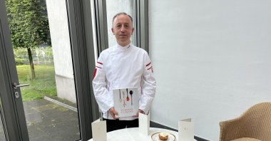 A Turkish chef stands behind a table showcasing Turkish food as part of Turkish Cuisine Week in Neuss, Germany, May 22, 2022. (AA Photo)