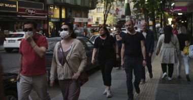 People walk along a street in Ankara, Turkey, April 26, 2022. (AP Photo)