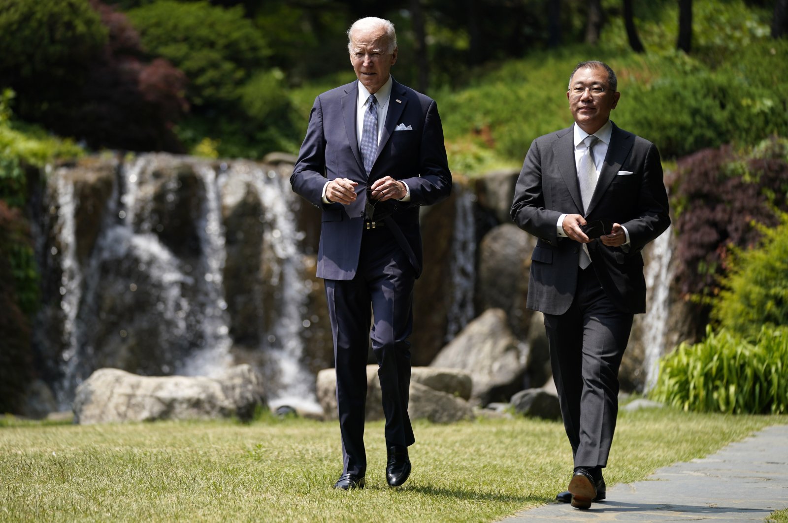 U.S. President Joe Biden (L) walks with Hyundai Motor Group Executive Chairperson Euisun Chung, at the Grand Hyatt Seoul, May 22, 2022, in Seoul. (AP Photo)