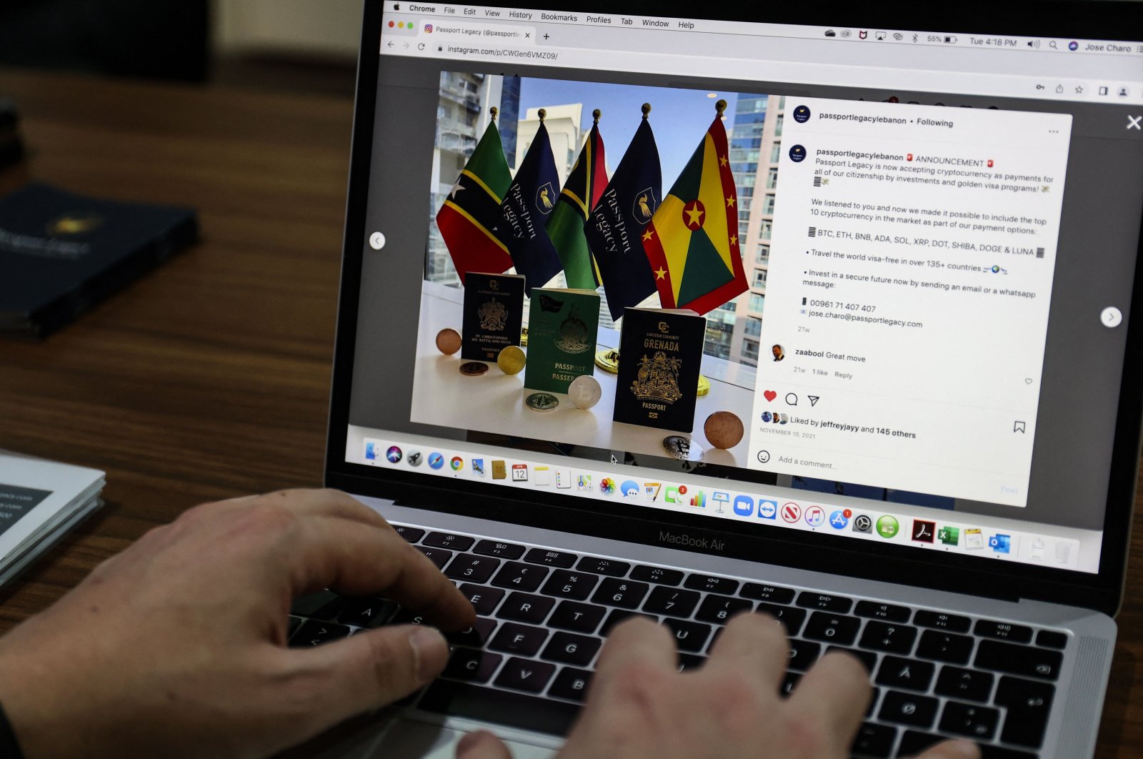 Jose Charo, head of the Beirut office of Passport Legacy, a Swiss-based company specializing in the industry of residency and citizenship by investment programs, shows the website of his company at his office in the Lebanese capital, April 12,  2022. (AFP Photo)