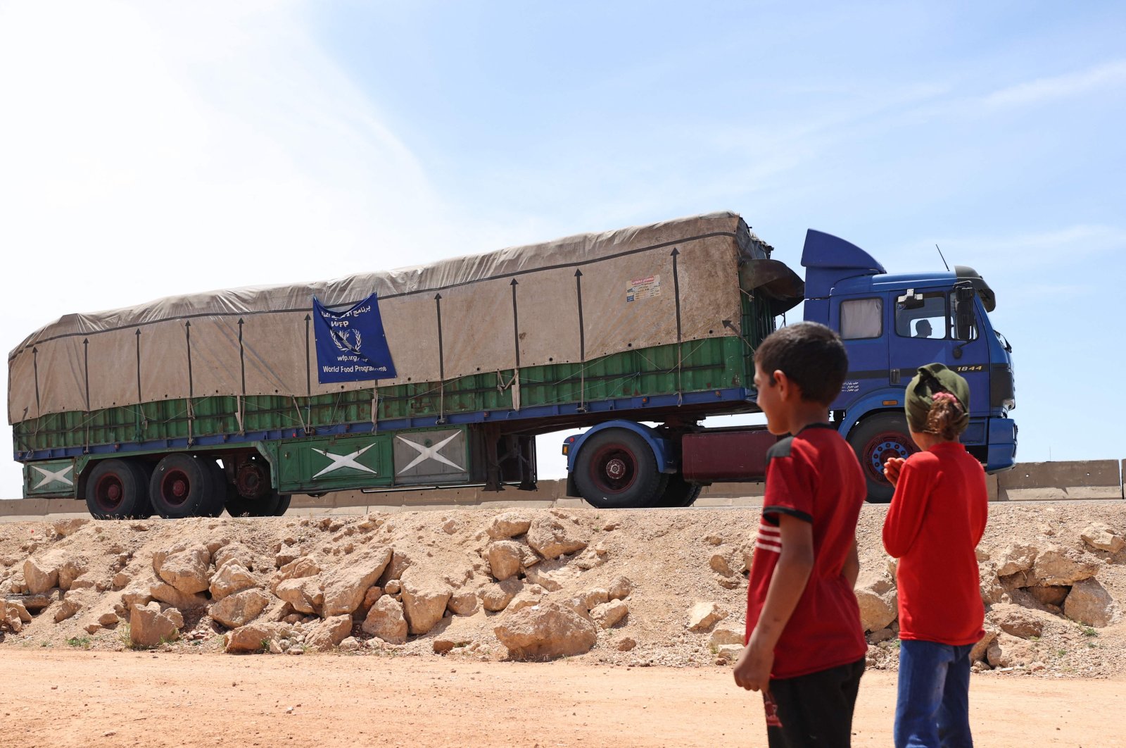 A truck carrying aid packages from the World Food Programme (WFP) drives through the town of Hazano in the opposition-held northern of Syria&#039;s Idlib province, May 16, 2022. (AFP Photo)