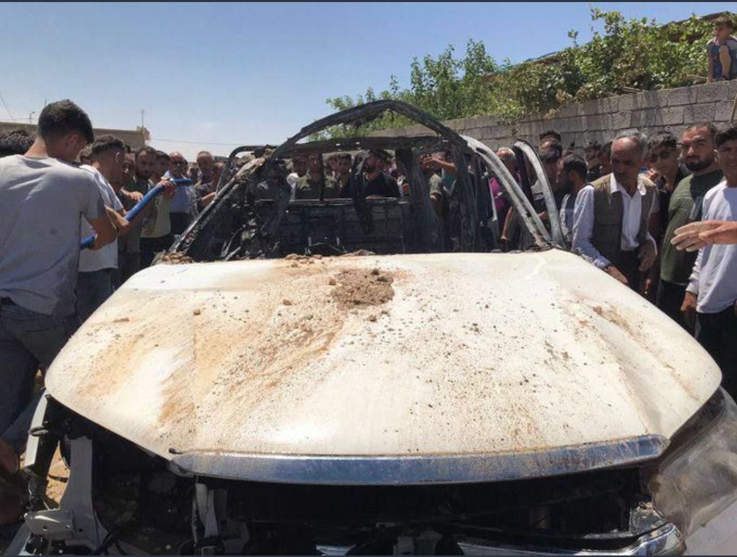 Onlookers inspect the PKK terrorist&#039;s vehicle following a Turkish intelligence operation in northern Iraq, in this photo released on May 23, 2022. (DHA Photo)