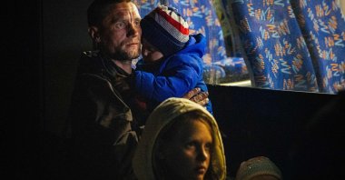 A man and his children arrive from Mariupol at a registration and processing area for internally displaced people, Zaporizhzhia, Ukraine, May 8, 2022. (AFP Photo)