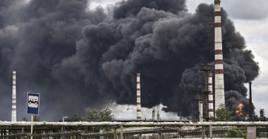 Smoke rises from an oil refinery after an attack outside the city of Lysychans in the eastern Donbass region, Ukraine, May 22, 2022. (AFP Photo)