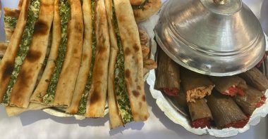 A wide variety of Turkish food is served across many countries as part of the newly launched Turkish Cuisine Week, a festival to promote Turkish cuisine internationally. In this photo, examples of Turkey&#039;s famous spinach pide and stuffed egglant are seen during Turkish Cuisine Week in Denizli, Turkey, May 22, 2022. (AA Photo)