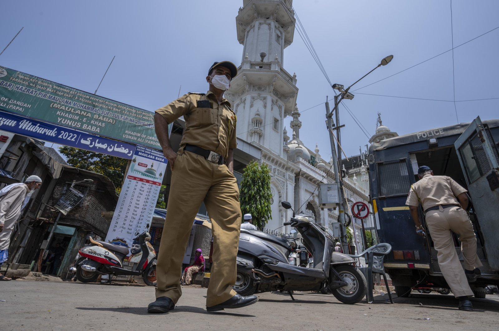 Police officers patrol outside a mosque as a man arrives to offer afternoon prayers in Mumbai, India, May 4, 2022. (AP Photo)